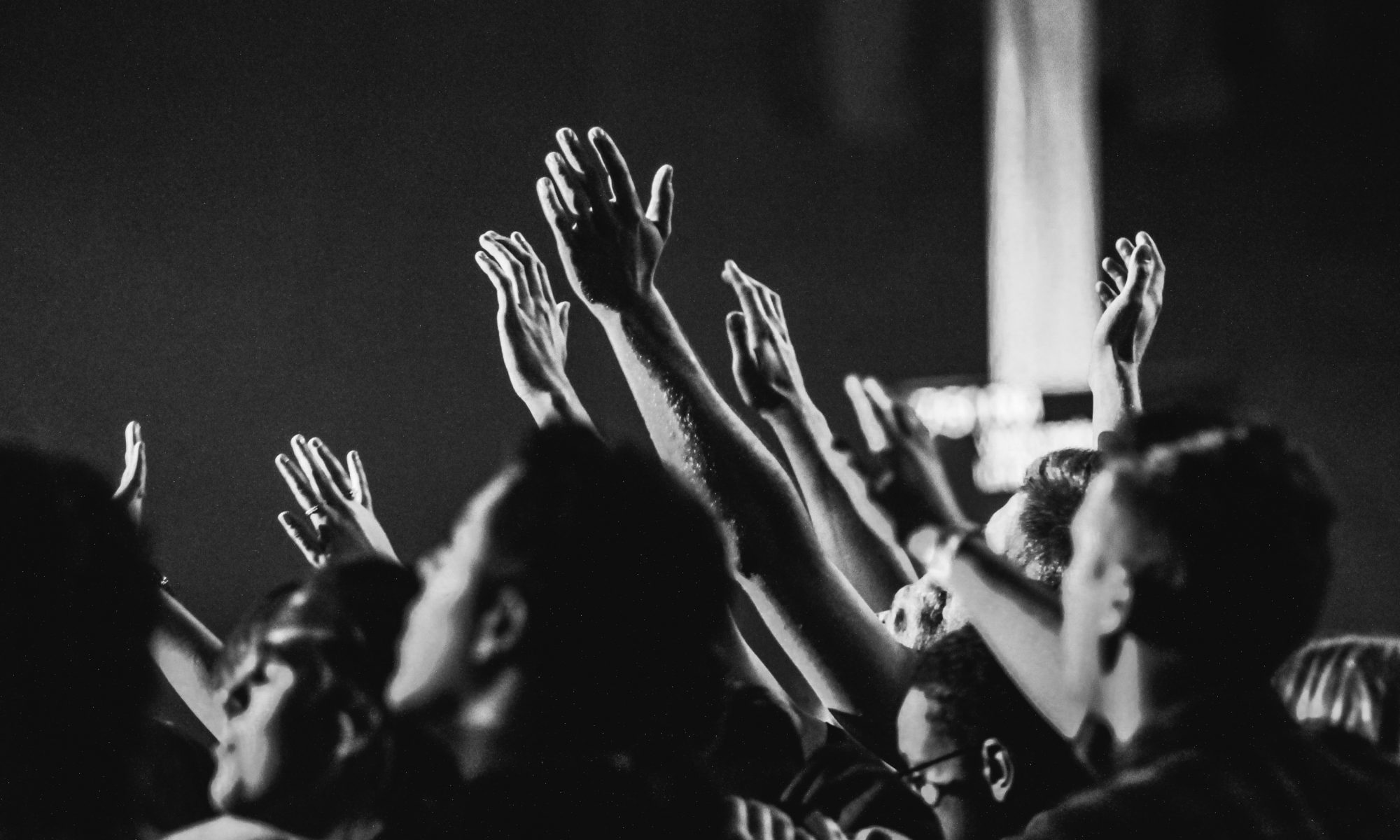 Crowd raising hands in worship